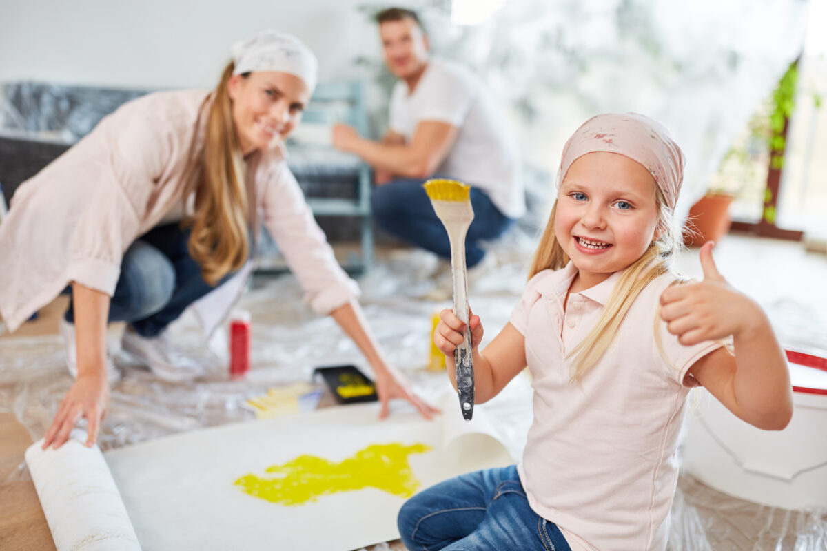 couple and their child painting together